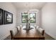 Dining room boasts a stylish light fixture and a view to the landscaped yard at 4813 E Earll Dr, Phoenix, AZ 85018