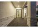 Covered entrance area with brick accents, tiled flooring, and a clear view into the home at 4813 E Earll Dr, Phoenix, AZ 85018