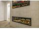 Modern fireplace with a large flatscreen above is encased in stone tiles and provides warmth at 4813 E Earll Dr, Phoenix, AZ 85018