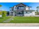 Stunning two-story home featuring a modern exterior, green lawn, and welcoming pathway to the front door at 4813 E Earll Dr, Phoenix, AZ 85018