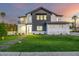Stunning two-story home featuring a modern exterior, green lawn, and welcoming pathway to the front door at 4813 E Earll Dr, Phoenix, AZ 85018