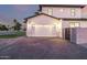 Well-lit garage area featuring a paved driveway, manicured landscaping, and ample parking space at 4813 E Earll Dr, Phoenix, AZ 85018
