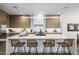 Beautiful kitchen island with modern light fixtures and seating at 4813 E Earll Dr, Phoenix, AZ 85018