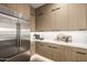 Pantry with stainless steel fridge and plenty of cabinet space at 4813 E Earll Dr, Phoenix, AZ 85018