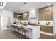 Modern kitchen features an island with bar seating, stainless steel appliances, and custom cabinets at 4813 E Earll Dr, Phoenix, AZ 85018