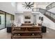 Elegant living room featuring a fireplace, open layout, high ceilings, and a floating staircase at 4813 E Earll Dr, Phoenix, AZ 85018