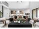 Bright, high-ceilinged living room with a stylish couch and a view into the kitchen at 4813 E Earll Dr, Phoenix, AZ 85018
