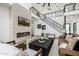 Stunning living room features a modern fireplace, soaring ceilings, and an open staircase at 4813 E Earll Dr, Phoenix, AZ 85018