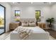 Bright main bedroom features two large windows, hardwood floors, neutral colored walls and stylish furniture at 4813 E Earll Dr, Phoenix, AZ 85018