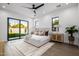 Main bedroom with floor to ceiling glass doors, windows and a large area rug on hardwood floors at 4813 E Earll Dr, Phoenix, AZ 85018