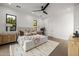 A well-lit main bedroom featuring a neutral color palette, ceiling fan, and hardwood flooring, and natural light at 4813 E Earll Dr, Phoenix, AZ 85018