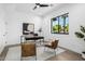 Home office with modern desk, neutral rug, and large window overlooking a beautifully landscaped yard at 4813 E Earll Dr, Phoenix, AZ 85018