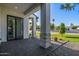 Covered patio featuring a tiled floor, gray columns, and access to a landscaped yard at 4813 E Earll Dr, Phoenix, AZ 85018