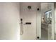 A glass shower with sleek, gray tiling and modern fixtures, and black hardware at 4813 E Earll Dr, Phoenix, AZ 85018