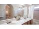Well-lit bathroom with double sinks, bathtub, and shower featuring tiled walls at 5515 E Elena Ave, Mesa, AZ 85206