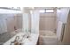 Bright bathroom showcasing a built-in tub with shower and a modern vanity at 5515 E Elena Ave, Mesa, AZ 85206