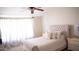 Relaxing bedroom featuring a tufted bed frame, soft lighting, and neutral color palette at 5515 E Elena Ave, Mesa, AZ 85206