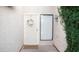 Close-up of a charming white front door with a decorative wreath and a 'Welcome' mat at 5515 E Elena Ave, Mesa, AZ 85206