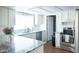 Bright kitchen featuring granite countertops, stainless steel appliances, and white subway tile backsplash at 5515 E Elena Ave, Mesa, AZ 85206