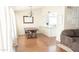 Open-concept living space with dining area, kitchen island, and modern furniture at 5515 E Elena Ave, Mesa, AZ 85206