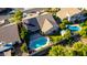 An aerial view shows a home with a sparkling pool, solar panels, and fenced yard at 5731 W Gail Dr, Chandler, AZ 85226