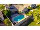 Aerial view showcases a home with solar panels, a backyard pool, and lush landscaping at 5731 W Gail Dr, Chandler, AZ 85226