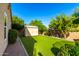 Backyard featuring a storage shed, artificial grass, and lush landscaping at 5731 W Gail Dr, Chandler, AZ 85226