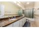 Bathroom featuring a long countertop with dual sinks and a shower-tub at 5731 W Gail Dr, Chandler, AZ 85226