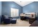 Comfortable bedroom with blue walls, modern loft bed, chair and ottoman at 5731 W Gail Dr, Chandler, AZ 85226