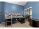 Stylish bedroom with blue walls, modern loft bed, storage, and closet at 5731 W Gail Dr, Chandler, AZ 85226