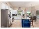 Bright kitchen showcasing stainless steel appliances and a blue island with granite countertops at 5731 W Gail Dr, Chandler, AZ 85226