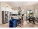 Spacious kitchen featuring white cabinetry, a granite-topped blue island, and a modern design at 5731 W Gail Dr, Chandler, AZ 85226