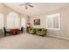 Bright living room featuring neutral carpet, plantation shutters, and a popcorn machine at 5731 W Gail Dr, Chandler, AZ 85226