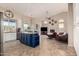 Open-concept living space with a large kitchen island and cozy living room with a fireplace at 5731 W Gail Dr, Chandler, AZ 85226