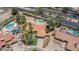 Aerial view showcasing the property with a pool, lush landscaping, and a tile roof at 6101 E Beck Ln, Scottsdale, AZ 85254