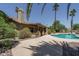 Backyard featuring the pool, patio cover, palm trees, and landscaping at 6101 E Beck Ln, Scottsdale, AZ 85254