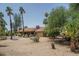 Lush backyard with mature trees, desert landscaping and access to the pool area at 6101 E Beck Ln, Scottsdale, AZ 85254