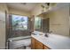 Bathroom featuring a tiled shower, glass door, and large mirror at 6101 E Beck Ln, Scottsdale, AZ 85254