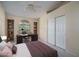 Bedroom with large window, desk, built-in shelves, and closet at 6101 E Beck Ln, Scottsdale, AZ 85254