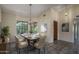 Inviting dining room area featuring a chandelier, large windows, and comfortable seating for six at 6101 E Beck Ln, Scottsdale, AZ 85254