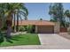 Inviting single-story home featuring a tile roof, well-manicured lawn, and a two-car garage at 6101 E Beck Ln, Scottsdale, AZ 85254