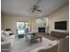 Bright living room with fireplace, ceiling fan, and sliding door access to a sparkling pool at 6101 E Beck Ln, Scottsdale, AZ 85254