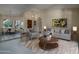 Comfortable living room showcasing neutral tones, modern furnishings, and an adjacent dining area at 6101 E Beck Ln, Scottsdale, AZ 85254
