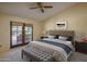 Comfortable main bedroom with patio access, neutral decor, and ample natural light at 6101 E Beck Ln, Scottsdale, AZ 85254