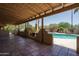 Spacious covered patio overlooking a sparkling pool and lush landscaping at 6101 E Beck Ln, Scottsdale, AZ 85254
