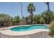 Refreshing backyard pool with diving board surrounded by desert landscaping and mature trees at 6101 E Beck Ln, Scottsdale, AZ 85254