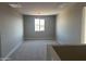 Spacious carpeted loft with ample natural light and neutral paint at 713 W Longwood Dr, Queen Creek, AZ 85140