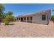 Spacious backyard with gravel, patio area, and desert landscaping at 7205 W Ellis St, Laveen, AZ 85339