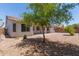 Backyard of home featuring gravel landscaping and a covered patio at 7205 W Ellis St, Laveen, AZ 85339