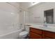 Bright bathroom features a tub with shower and single sink vanity at 7205 W Ellis St, Laveen, AZ 85339